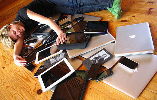 Woman with multiple mobile devices